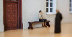 Miniaturowa figurka mężczyzny na ławce z wystawy Trefl Miniatury w Gdyni